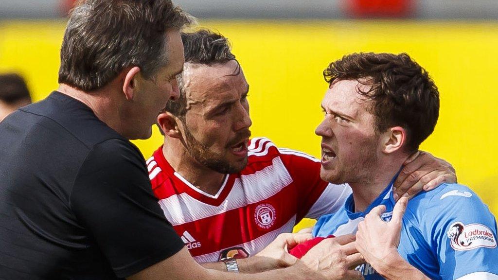 St Johnstone midfielder Danny Swanson (right) is restrained against Hamilton