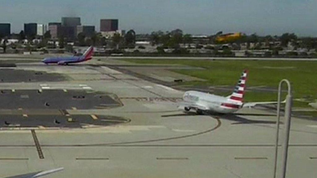 Harrison Ford's plane flys over an airliner