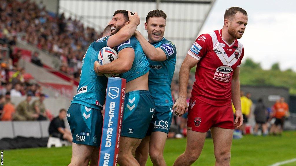 Wigan Warriors celebrate an Abbas Miski try against Salford Red Devils