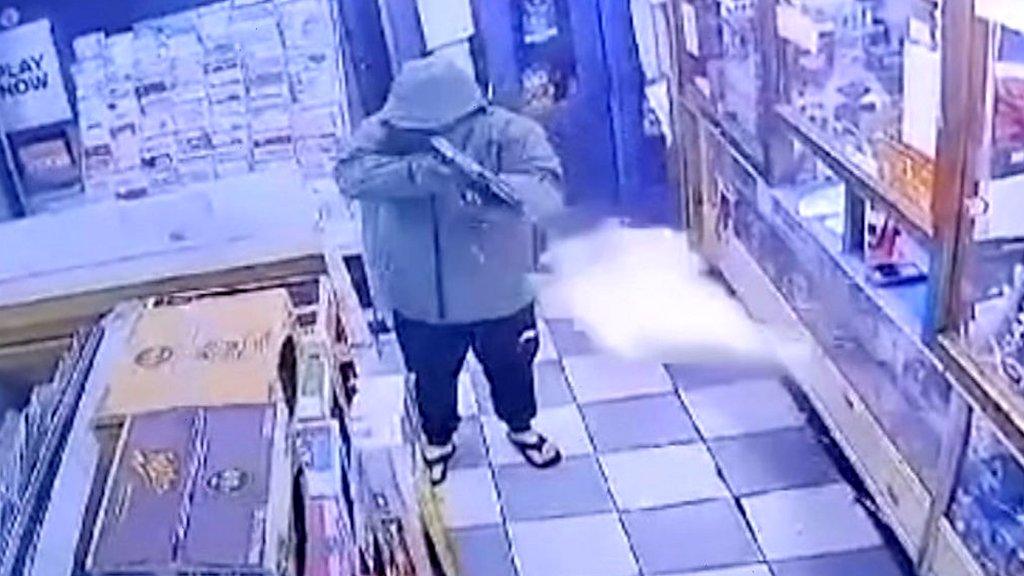 Man with gun in newsagents