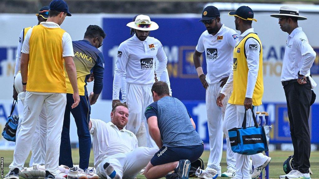 Paul Stirling receives treatment before having to come off the field in Galle