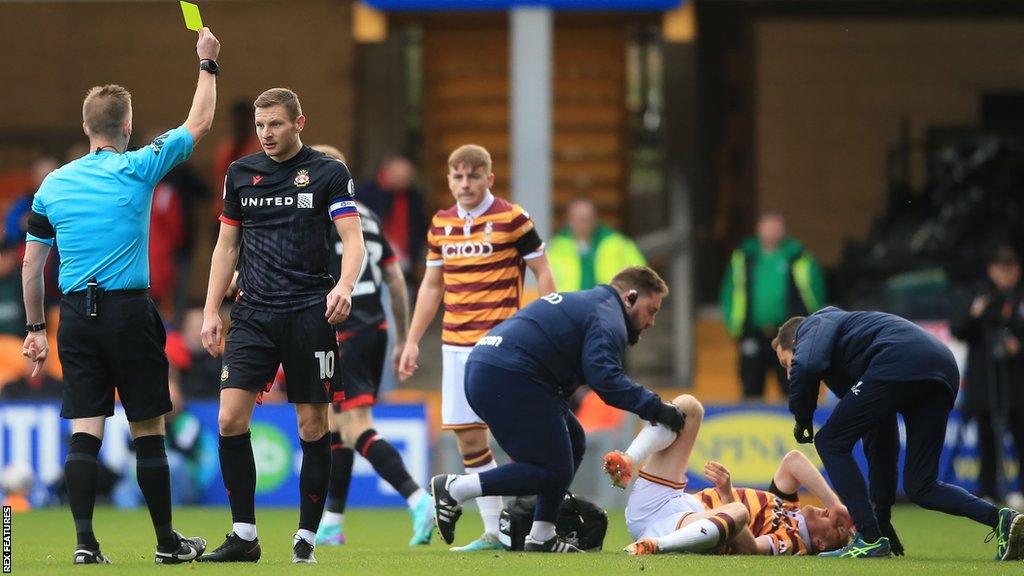 Wrexham striker Paul Mullin was booked for an early foul