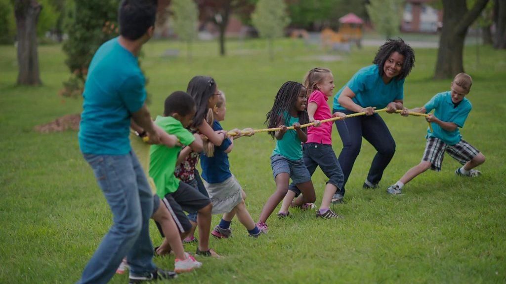 Adults and children playing