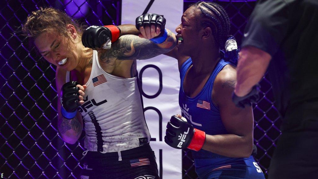 Kelsey De Santis (L) is punched by Claressa Shields