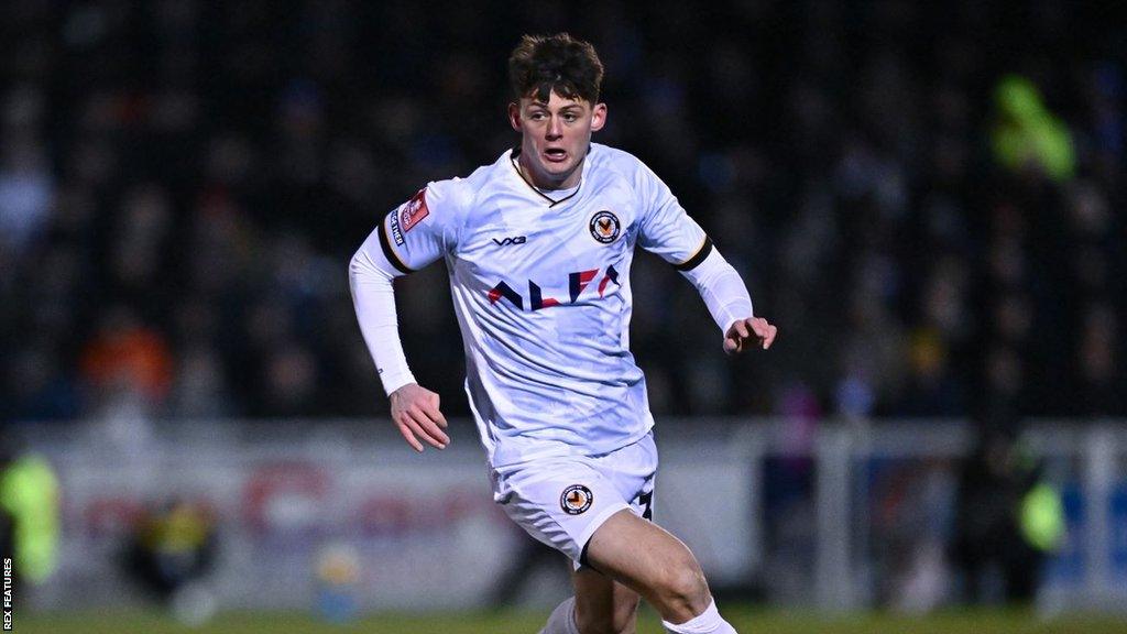 Seb Palmer-Houlden running with the ball during a Newport game