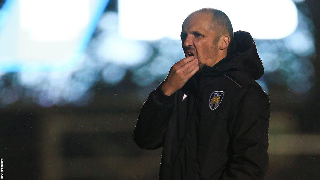 Colchester United interim head coach Matthew Etherington watches training