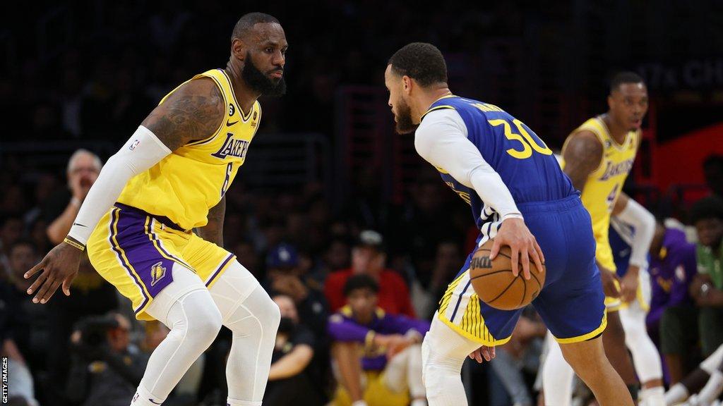 Stephen Curry of the Golden State Warriors goes up against LeBron James of the LA Lakers