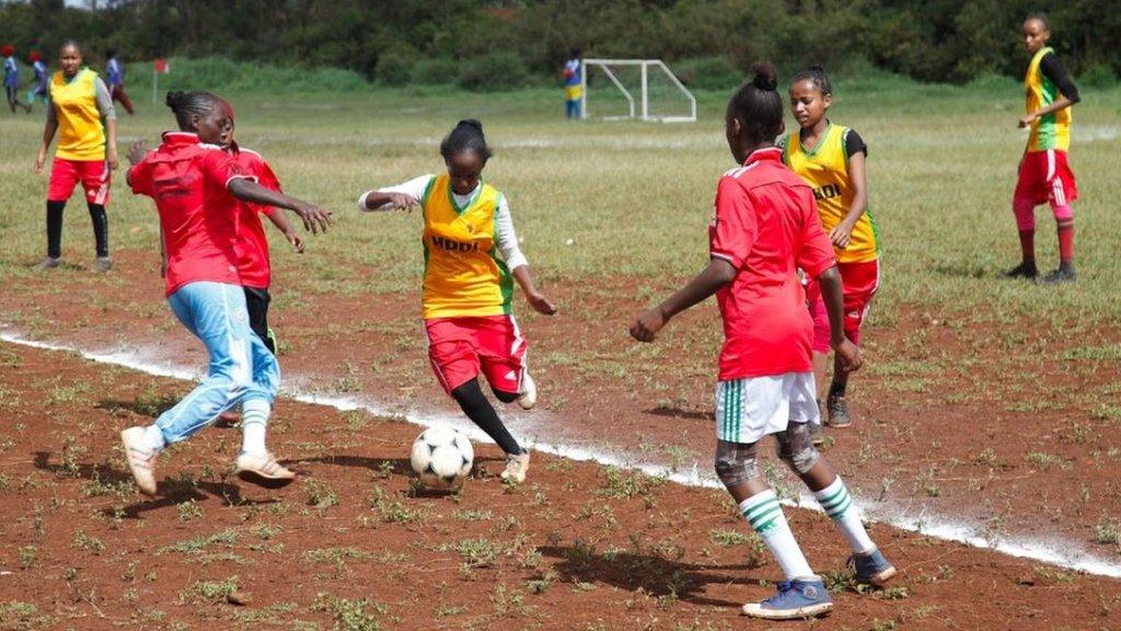 Girls playing football