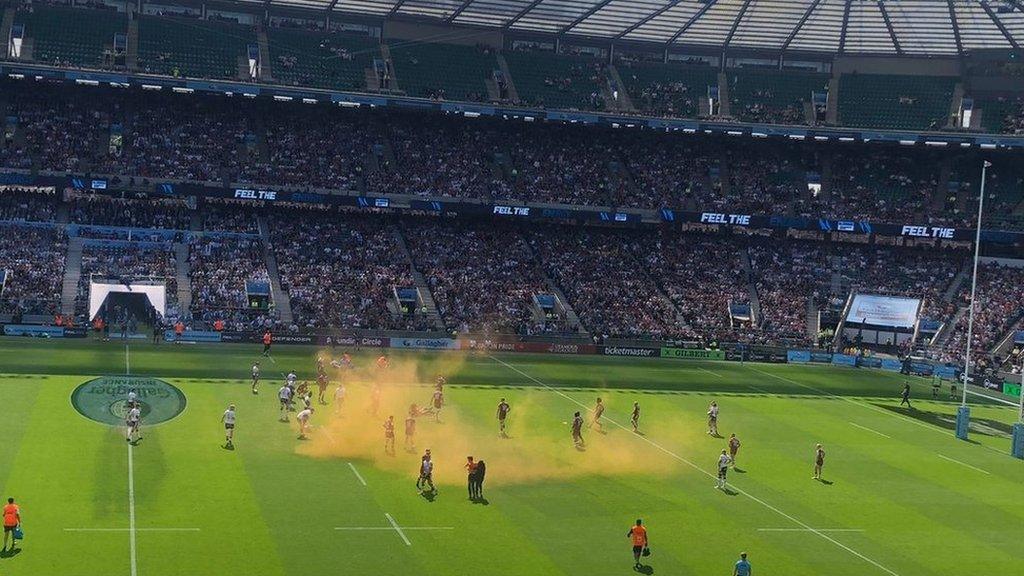 Protestors let off orange smoke bombs