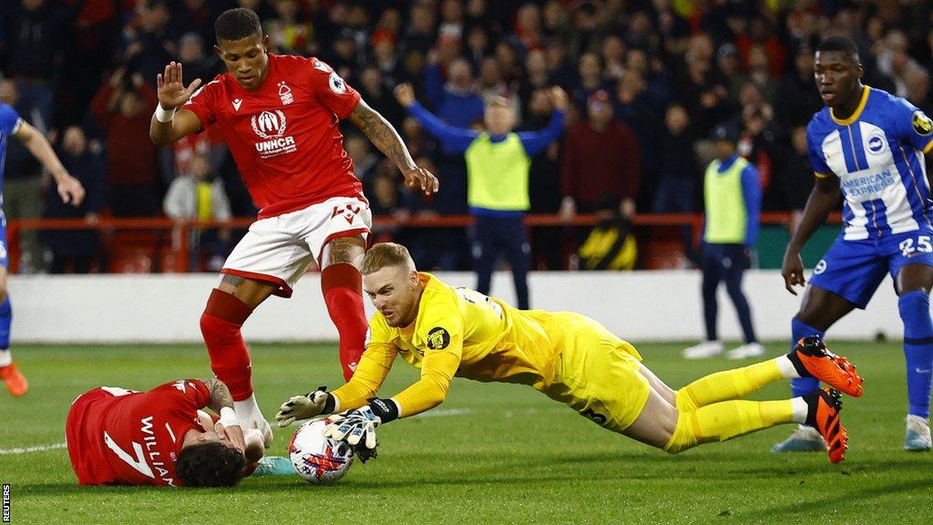 Nottingham Forest's Neco Williams reacts after sustaining an injury as Brighton & Hove Albion's Jason Steele dives for the ball