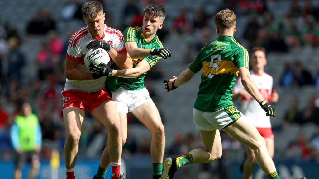 Derry's Dara Rafferty with Chris O’Donoghue of Kerry