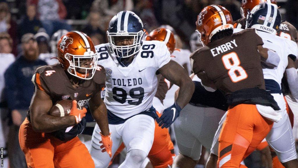 Bowling Green Falcons running back Terion Stewart runs the ball against Toledo Rockets defensive end Desjuan Johnson