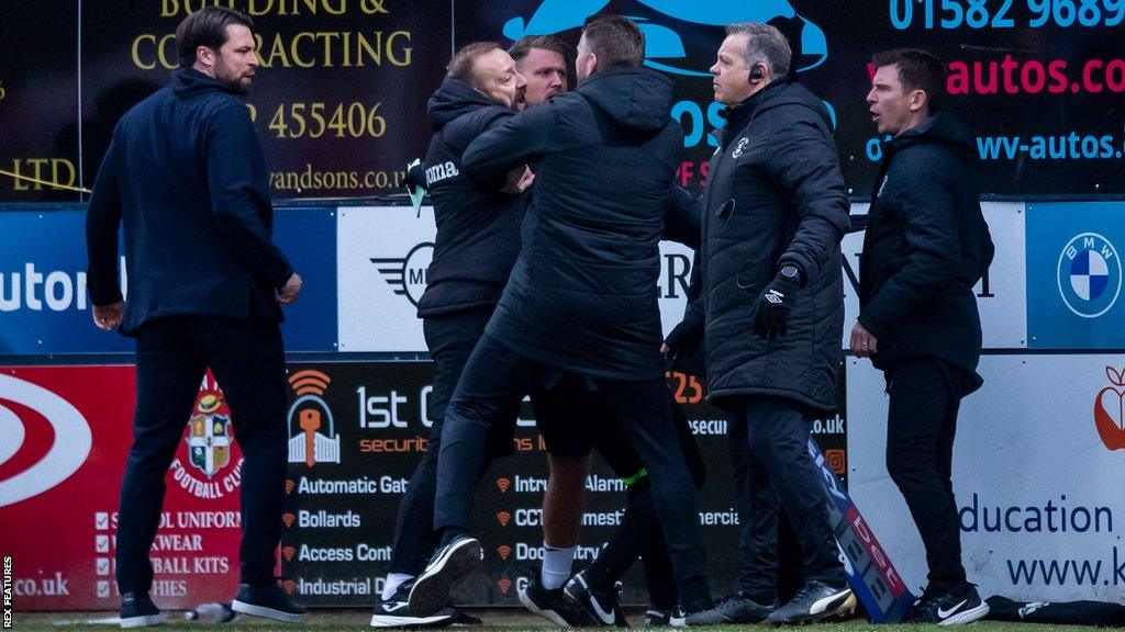 Swansea assistant coach Matt Gill (second left) tangles with Luton boss Rob Edwards at the start of a melee which saw Russell Martin (left) and Luton assistant boss Richie Kyle (right) shown red cards