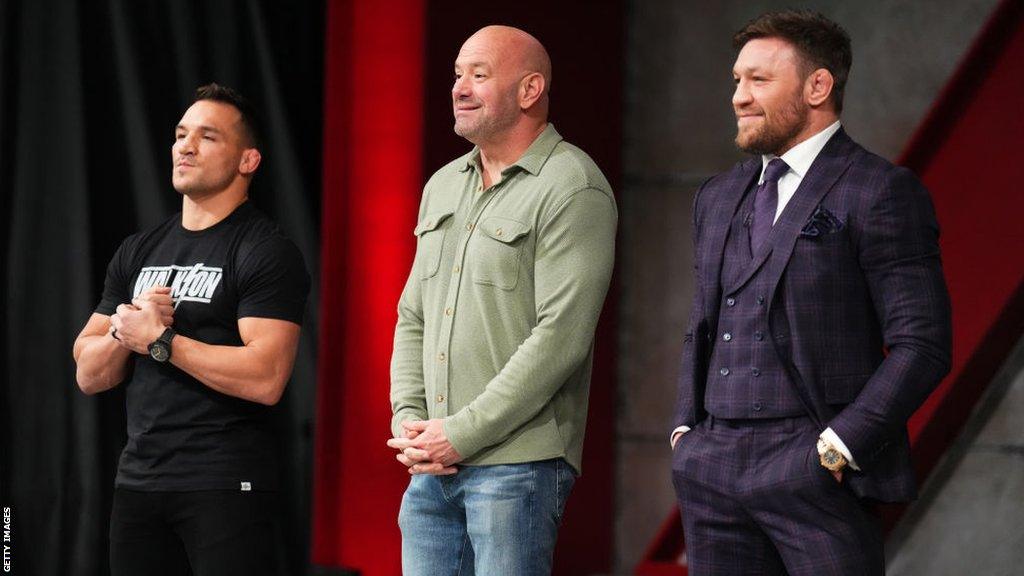 Dana White stands in between Michael Chandler and Conor McGregor