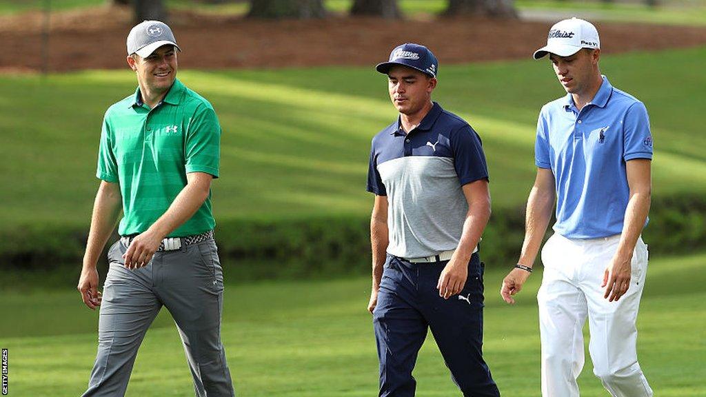 Jordan Spieth with Rickie Fowler and Justin Thomas walking down a fairway during a practice round for The Players Championship in 2016