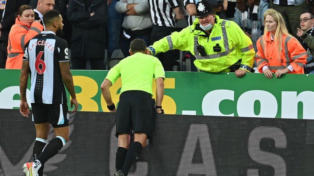 Official alerted to a medical emergency in the stands at Newcastle