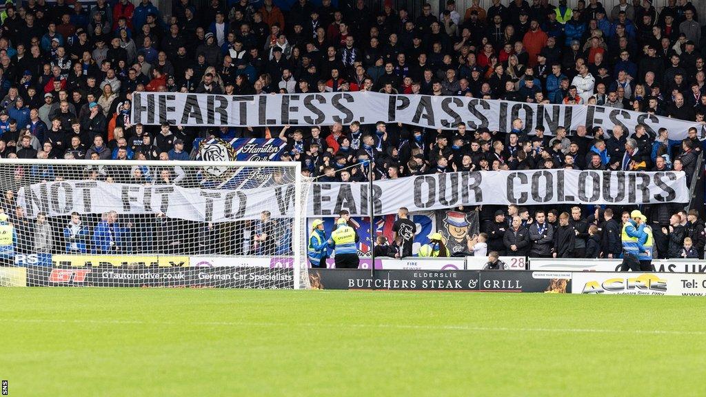 Rangers supporters displaying banners at St Mirren Park