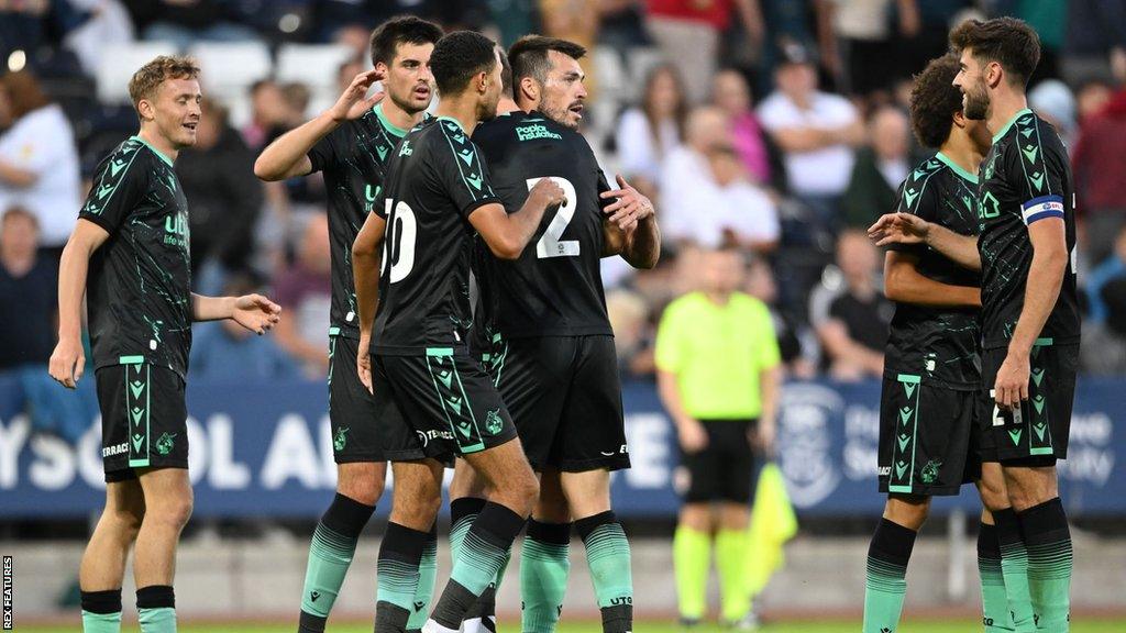 Bristol Rovers players celebrate a goal during their pre-season friendly win over Swansea