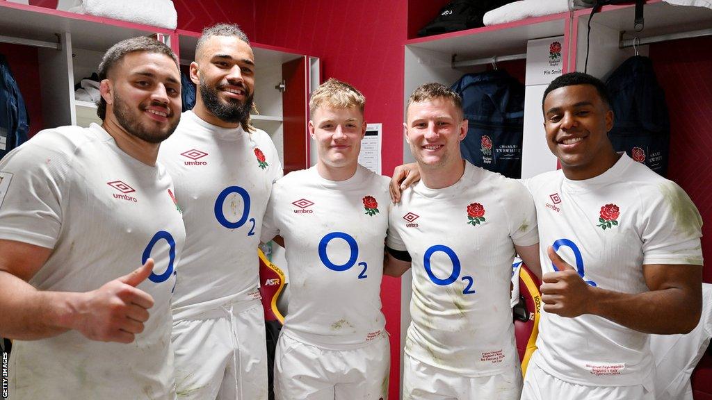 Ethan Roots, Chandler Cunningham-South, Fin Smith, Fraser Dingwall and Immanuel Feyi-Waboso of England pose for a photo inside the dressing room