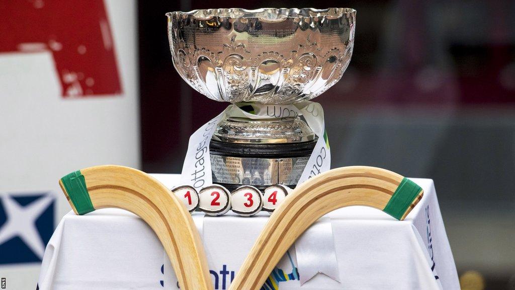 Shinty sticks and a trophy