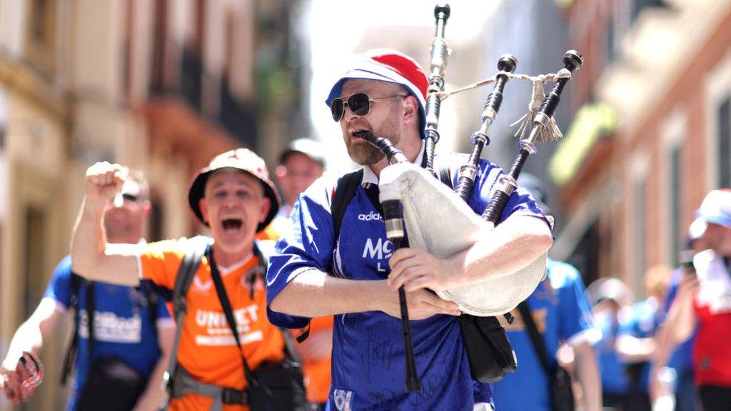 A Rangers fan plays bagpipes