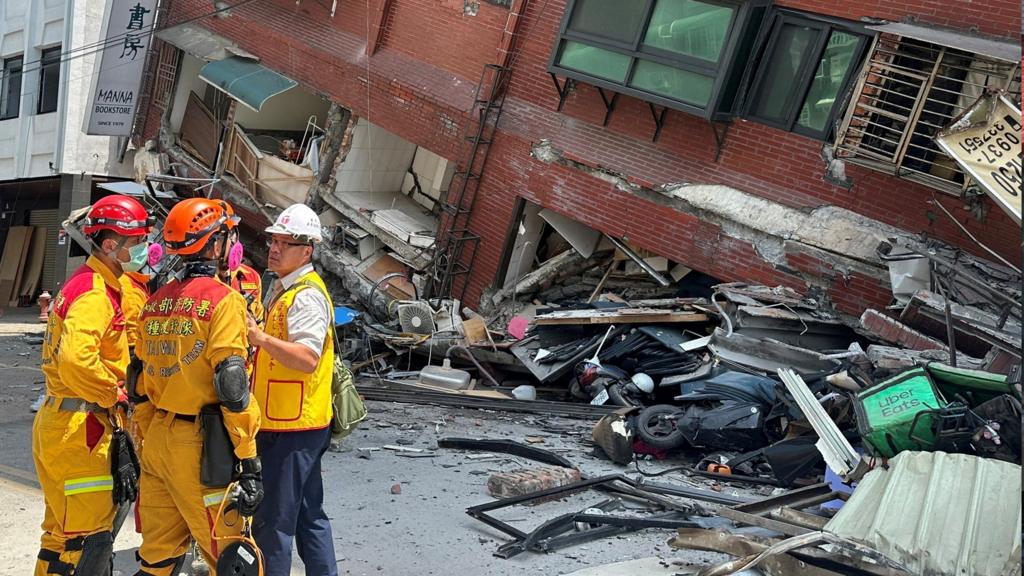 Firefighters work at the site where a building collapsed following the earthquake, in Hualien, Taiwan on 3 April 2024