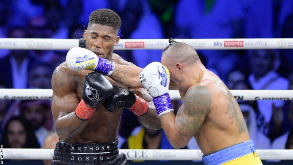 Anthony Joshua winces at a jab thrown by Oleksandr Usyk in their Saudi Arabia fight in August