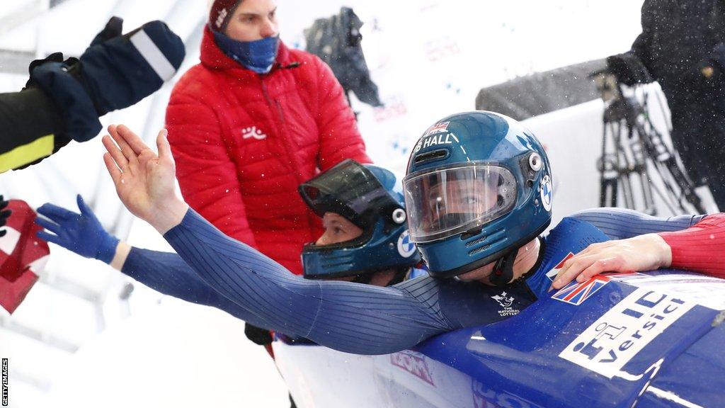 Brad Hall (R) and Taylor Lawrence of Great Britain react after their second run of the two-men bob competition at the IBSF Bobsleigh World Cup event in Sigulda, Latvia