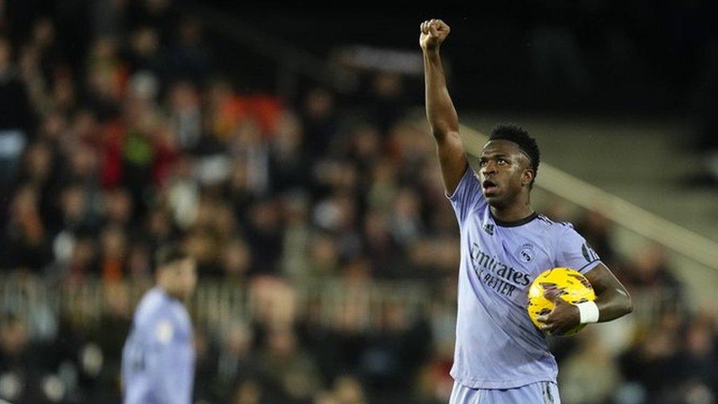 Vinicius Jr celebrating by raising his right fist into the air after scoring against Valencia