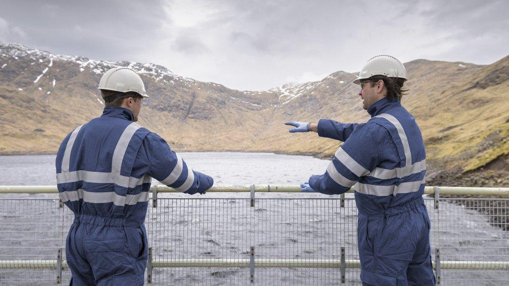 Two workers on a dam