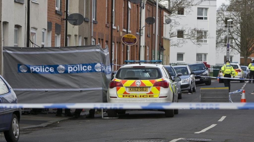 Crime scene with police car outside house in Stanley Road, Northamptonshire