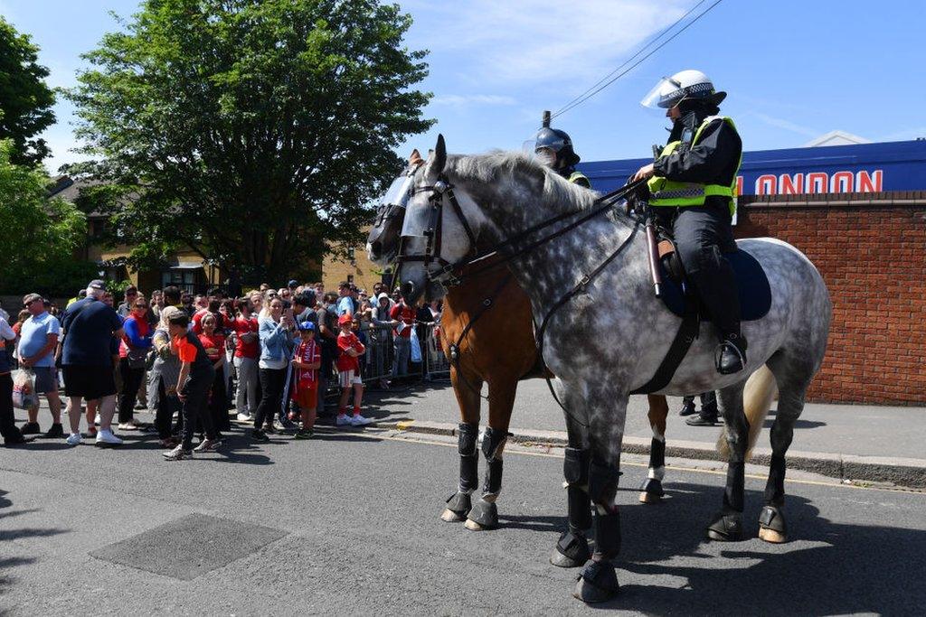 Police officers on horseback help to keep order at Crystal Palace's match against Manchester United