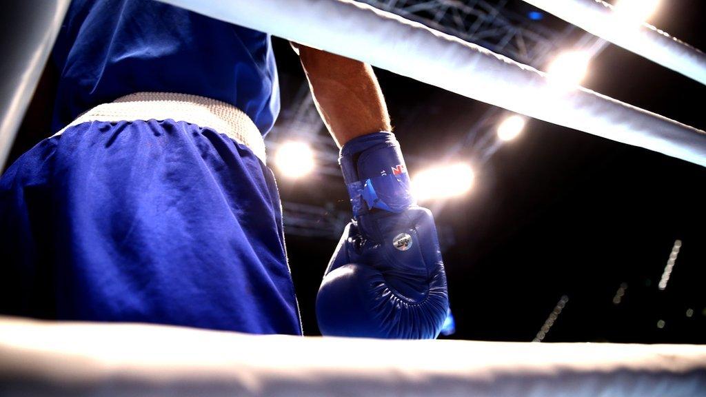 A boxer waits in his corner