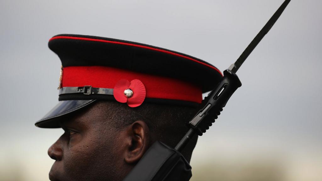 A soldier prepares for The Armistice Day Service at The National Memorial Arboretum on November 11, 2016