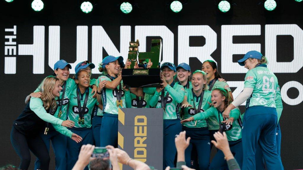 women cricketers win the hundred in 2021 lifting the trophy