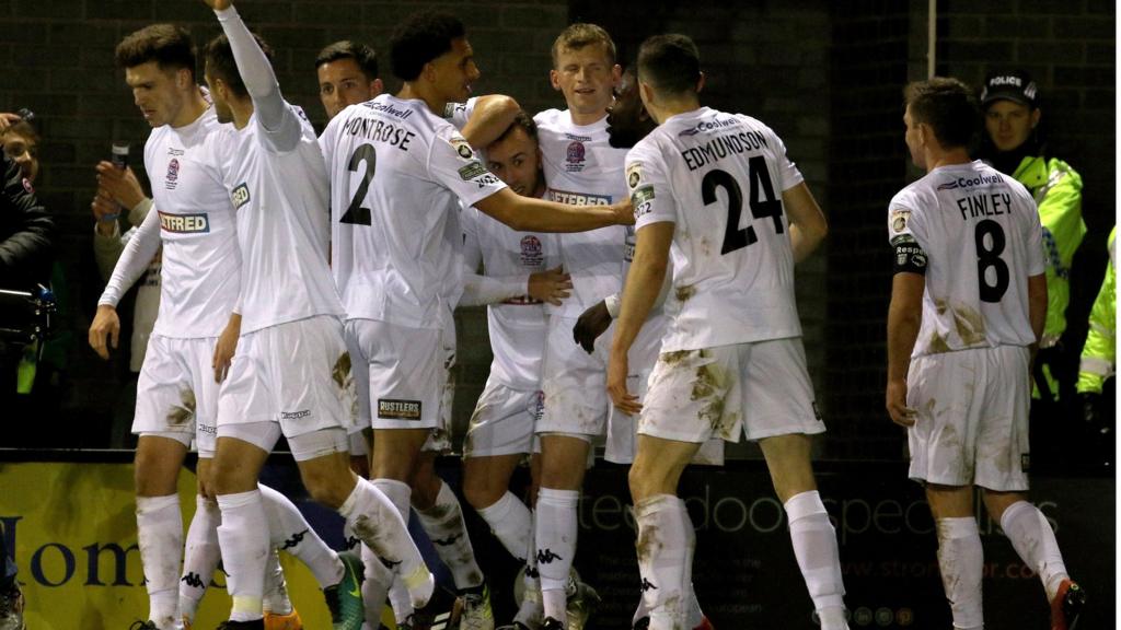 Fylde players celebrate scoring against Wigan