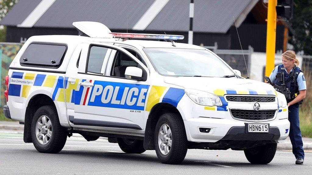 This picture released by Radio New Zealand shows a police officer cordoning a street near the mosque after a firing incident in Christchurch on March 15, 2019