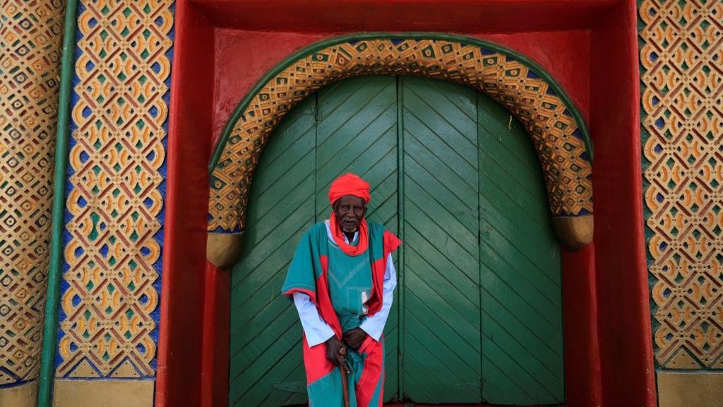 A man stands outside the Emir of Kano's palace in Nigeria