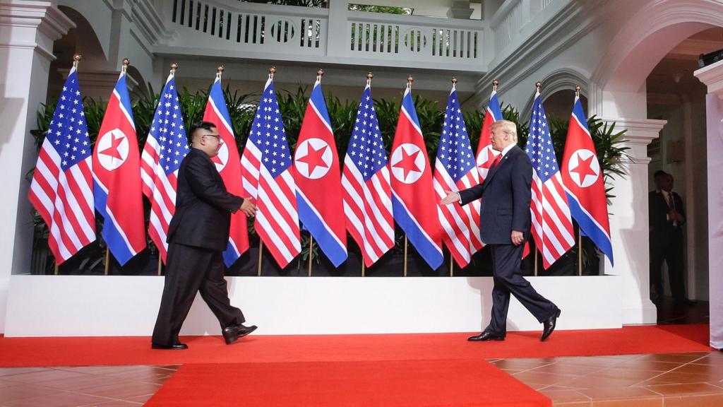 Kim Jong-un and Donald Trump shake hands