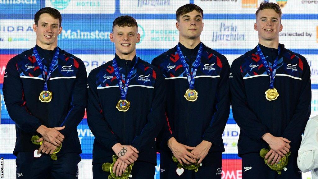 Great Britain's 4x50m men's freestyle relay team on the podium after winning gold at the European Short Course Swimming Championships