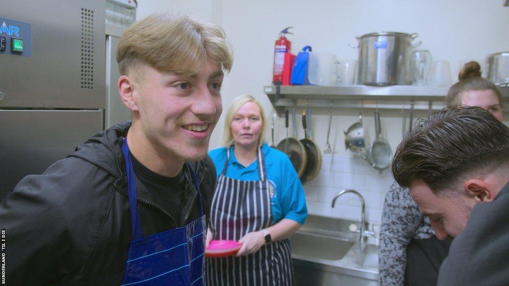 Jack Clarke and Patrick Roberts helping out in kitchen for charity.