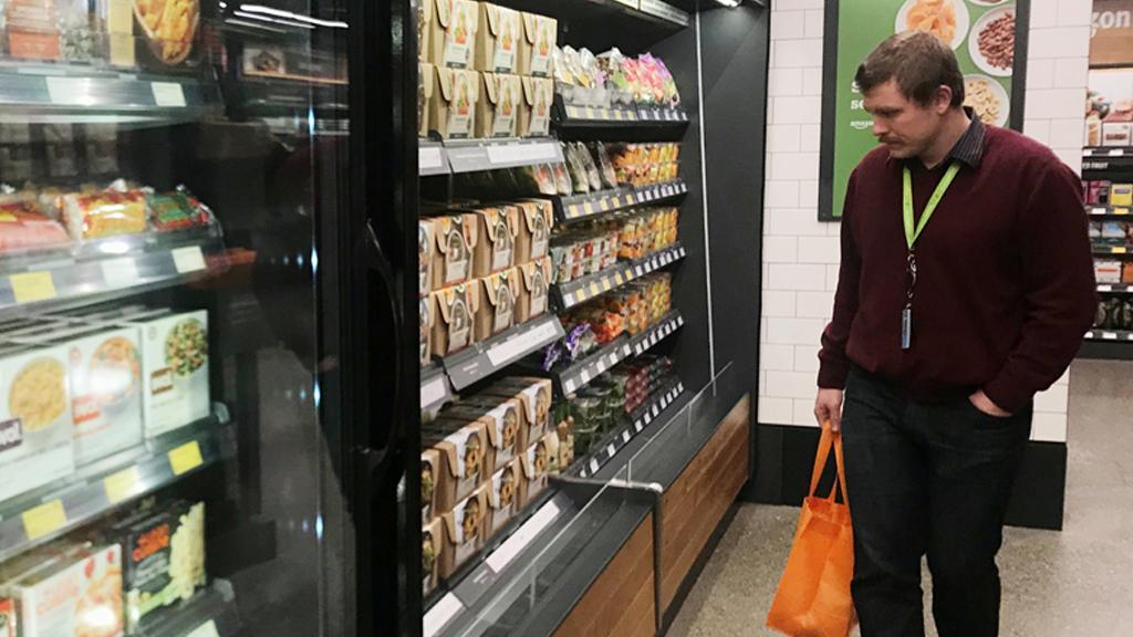 A shopper is seen using his phone in the line-free, Amazon Go store in Seattle, Washington, U.S., January 18, 2018