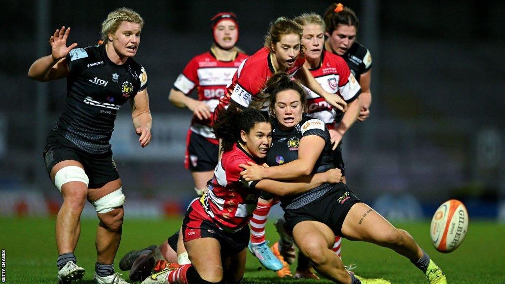 Exeter and Gloucester-Hartpury players wrestle for control of the ball