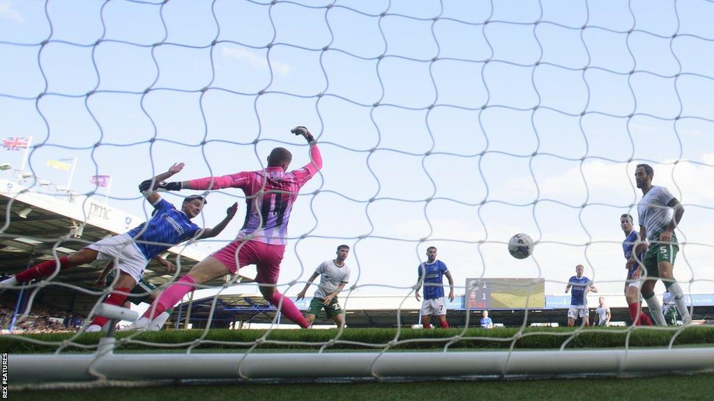 Regan Poole (left) scores Portsmouth's second goal during their League One match against Lincoln City at Fratton Park.