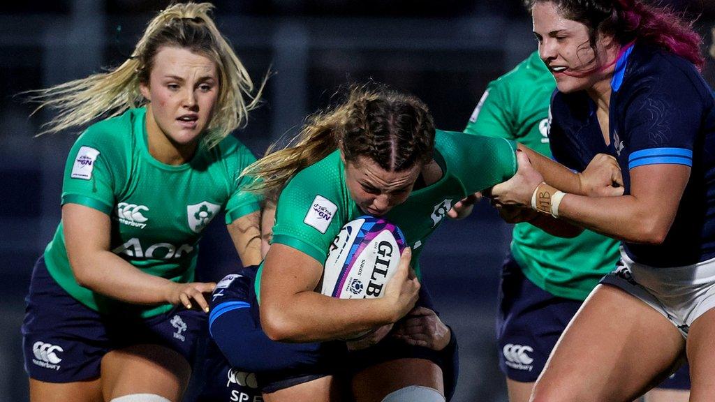 Aoife Dalton and Brittany Hogan try to drive Ireland forward against Scotland