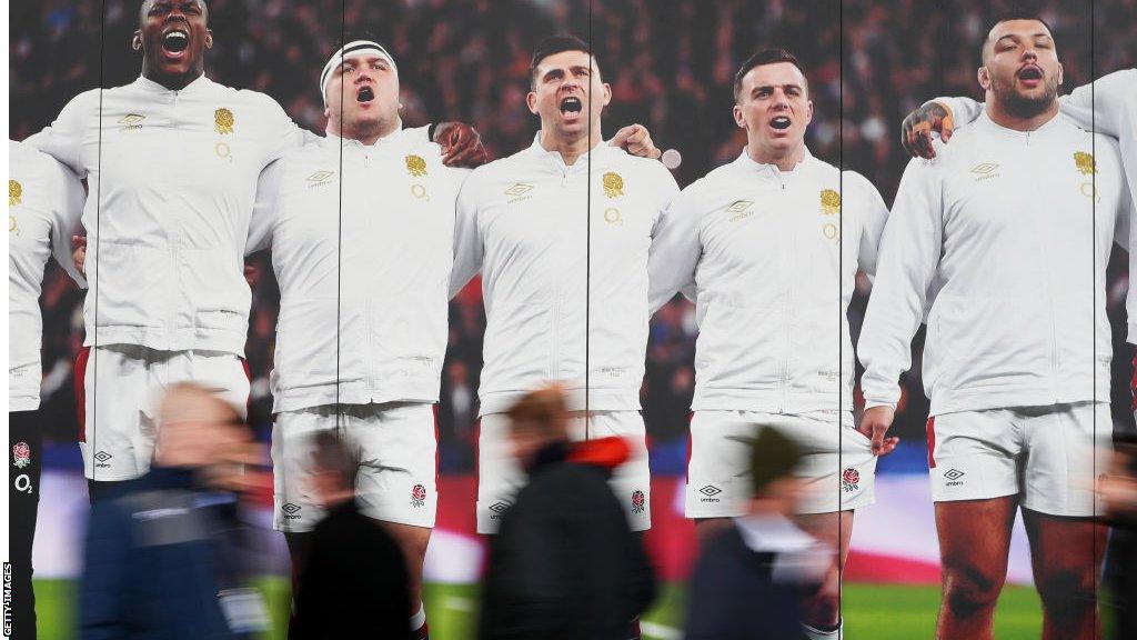 England players on an advertising hoarding at Twickenham