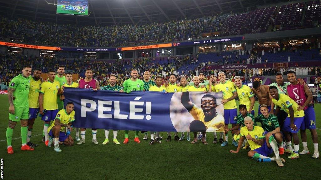 Brazil players hold a banner showing support for former Brazil player Pele