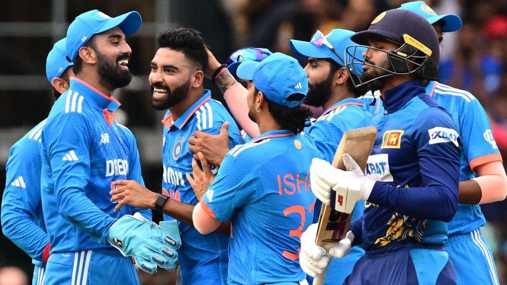 India celebrate after fast bowler Mohammed Siraj takes a wicket against Sri Lanka