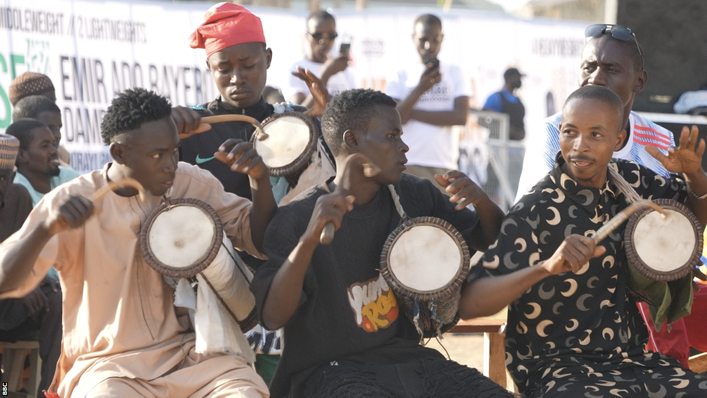 Three drummers play traditional Kalangu drums at the Emir Ado Bayero Dambe Championship