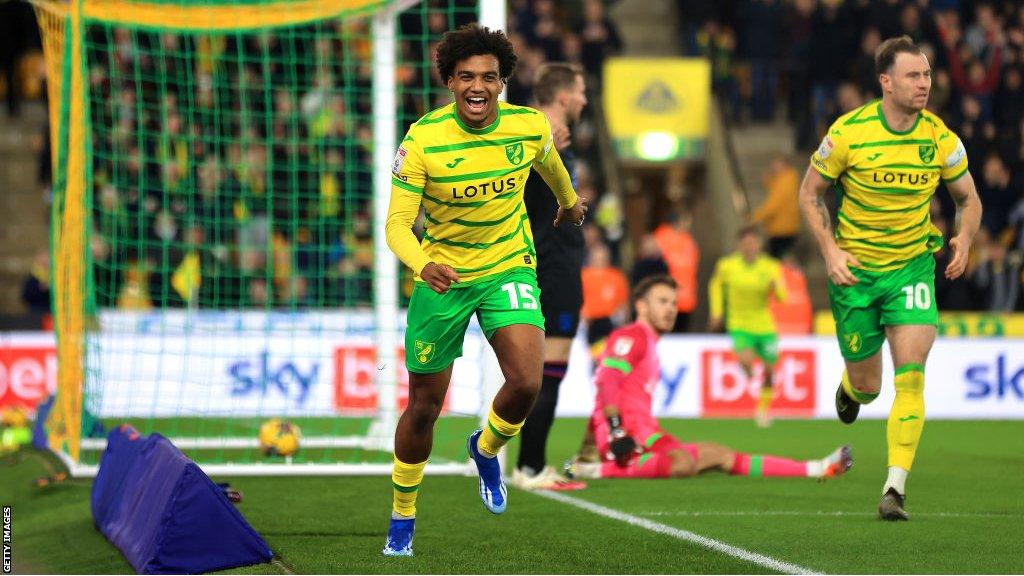 Sam McCallum of Norwich City celebrates scoring the opening goal against Huddersfield Town